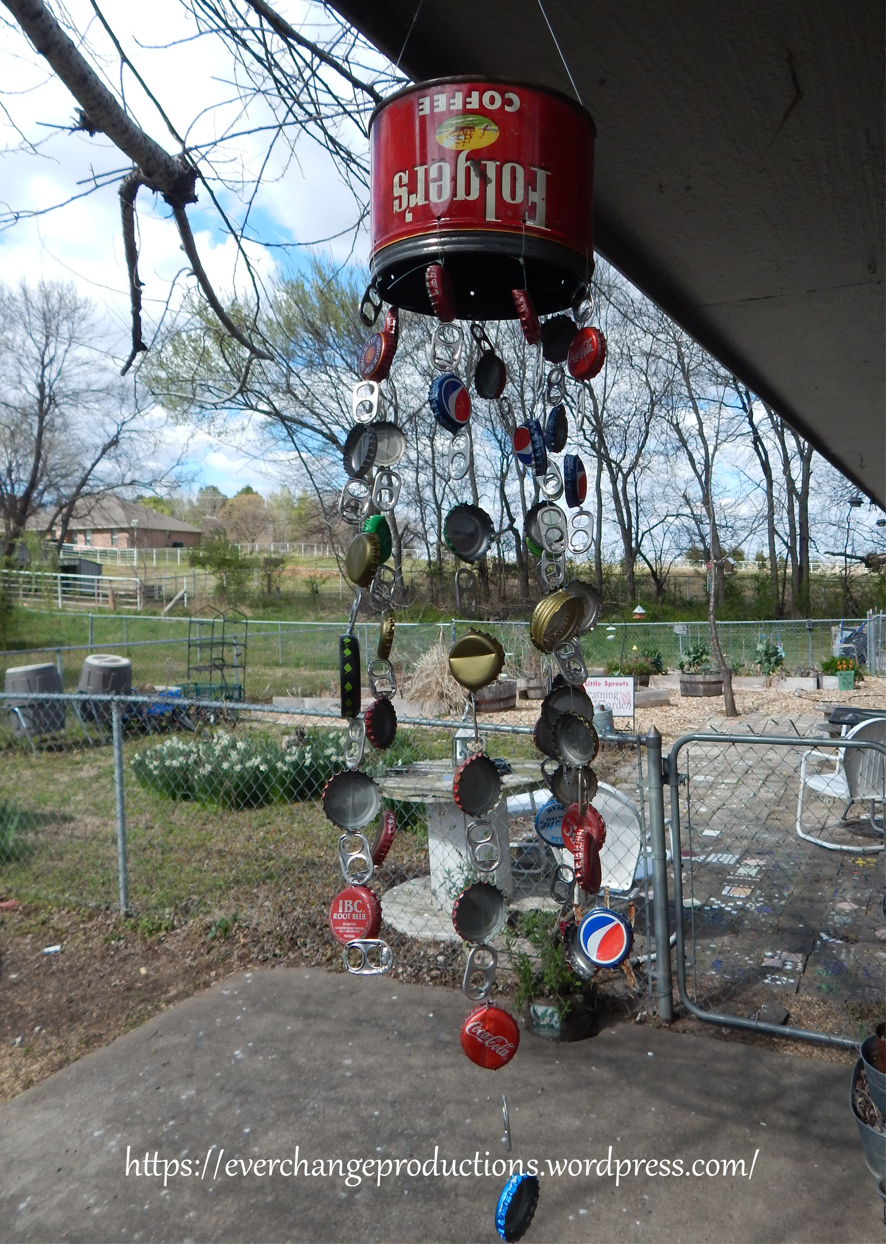 An upcycled windchime made from a vintage coffee can, pop tabs and pop bottle caps.